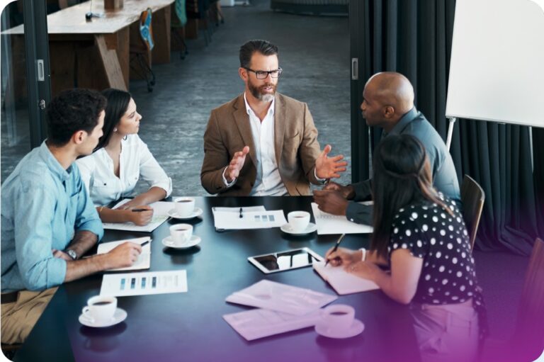 Group of people at desk having a meeting